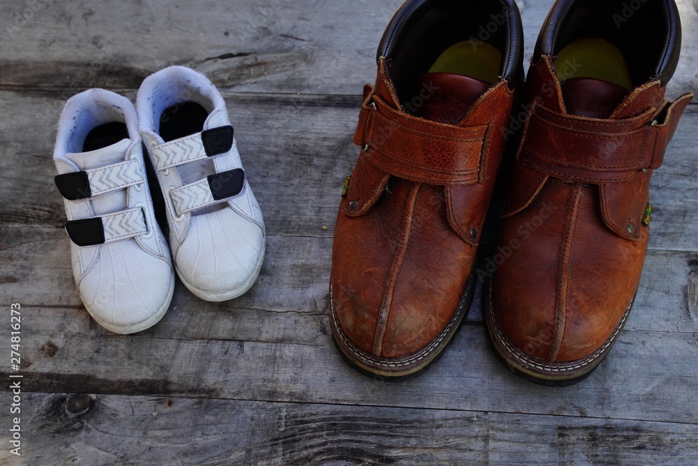Daddy's boots and baby's shoes, fathers day concept