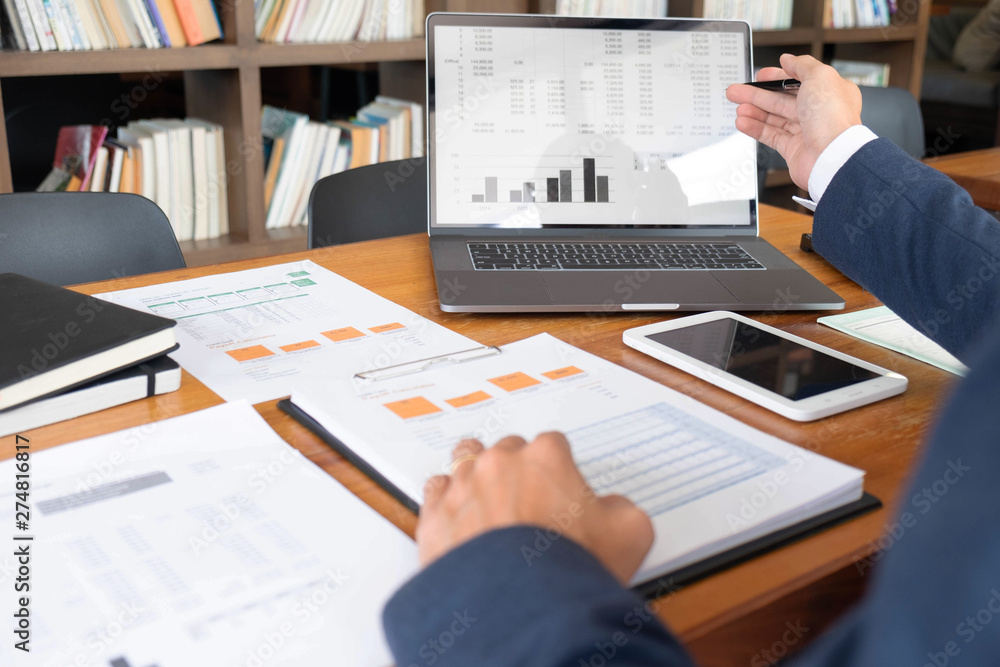 Fototapeta premium Businessmen, finance, accounting work, checking accounts, using calculators and finding information