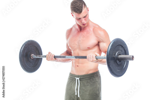 Muscular man working out in studio doing exercises with barbell at biceps, strong male naked torso abs. Isolated on white background. Copy Space.