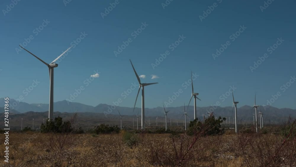Windmills spinning in dry desert landscape. Windmills spinning in dry desert landscape.