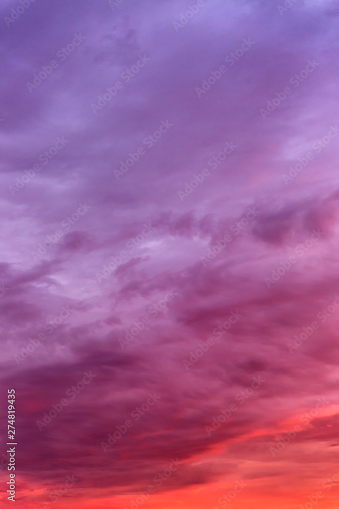 Beautiful fiery sunset on the sky. Gorgeous landscape. Background. Vertical.