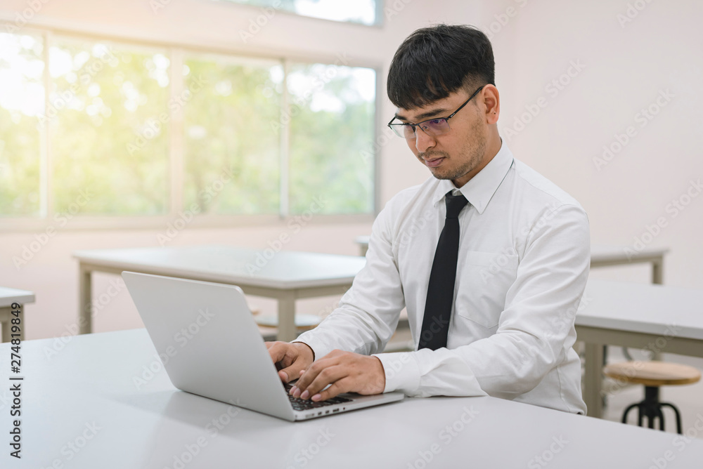Young businessman working with laptop at office Young businessman working with laptop at office