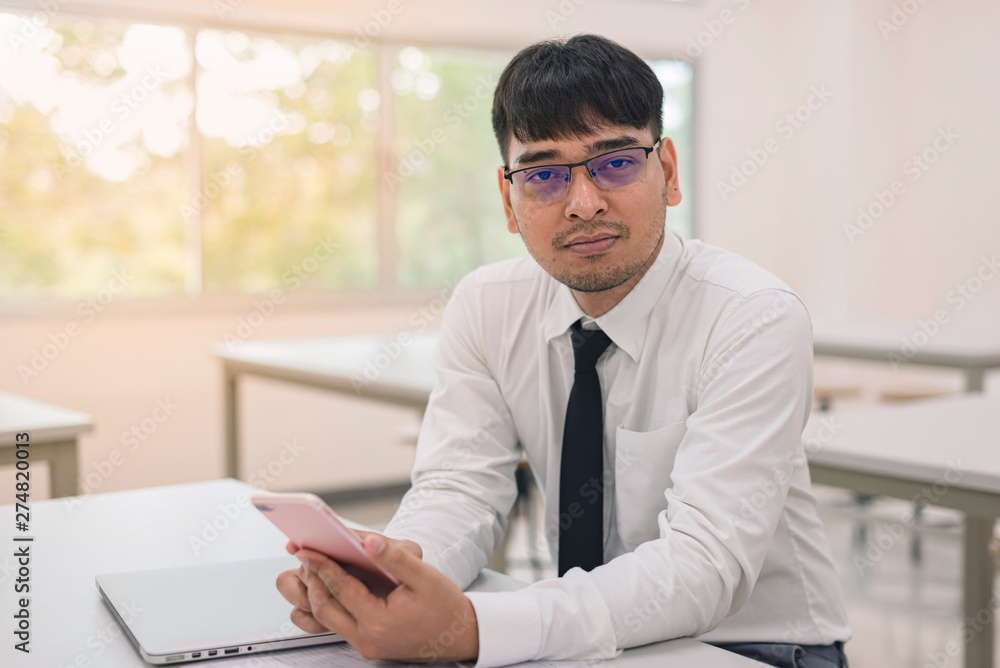 Obraz premium Young business man working at office with laptop, mobile and documents