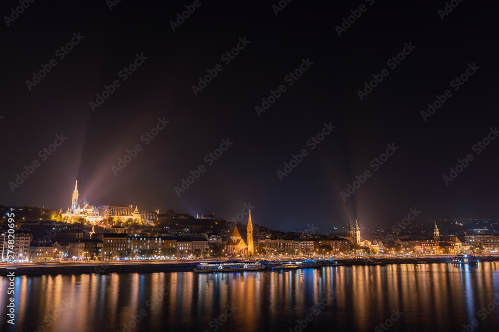 Night view of the Matthias Church and River Danube bank
