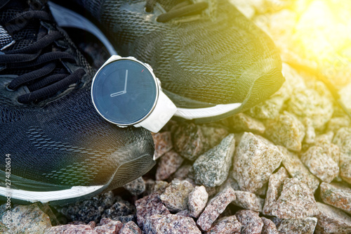 Sport watch for crossfit and triathlon on the running shoes. Smart watch for tracking daily activity and strength training. Sun beam lights.