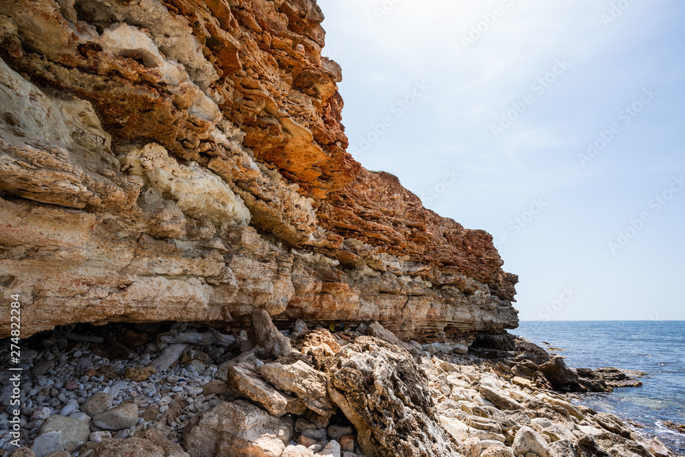 Wild and picturesque sea shore with stones on Crimean coast of Black sea in the area of Chersonesos cape.