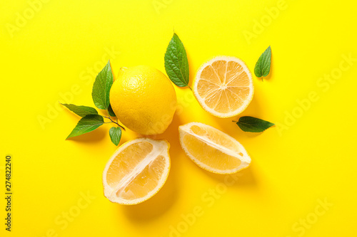 Flat lay composition with lemons on color background, space for text
