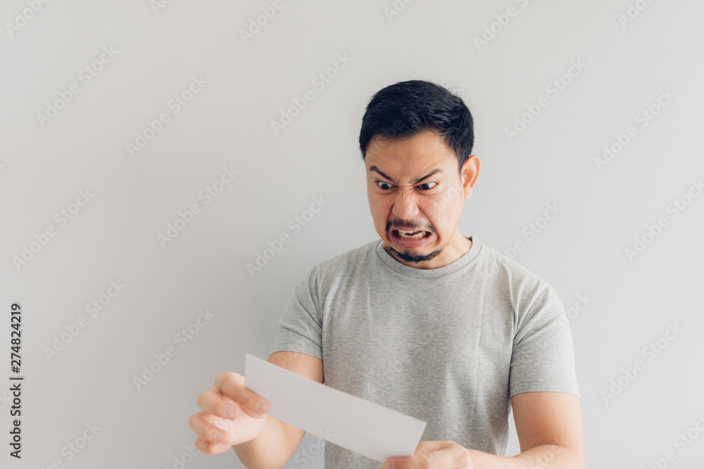 Man is angry with the white mail message or the bill. Man is angry with the white mail message or the bill.