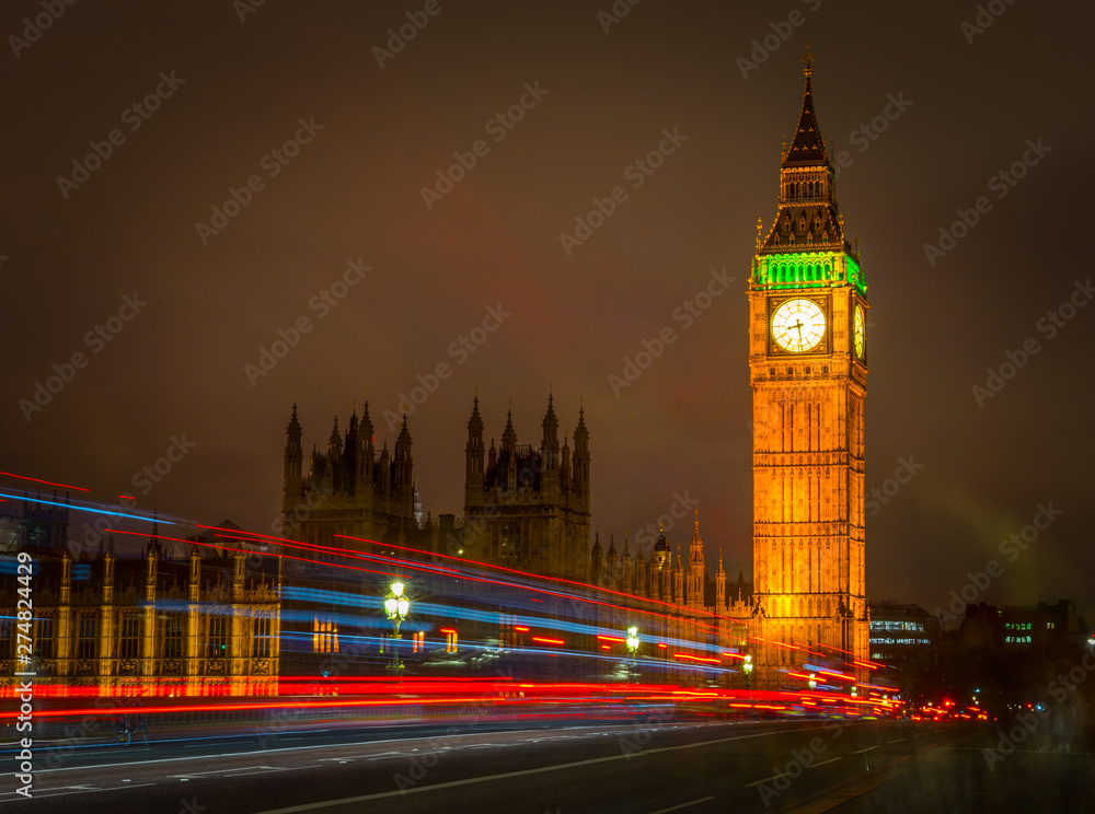 Big Ben Houses of Parliament Westminster Palace gothic architecture and Light trail from double decker bus passing on Westminster Bridge, London, England
