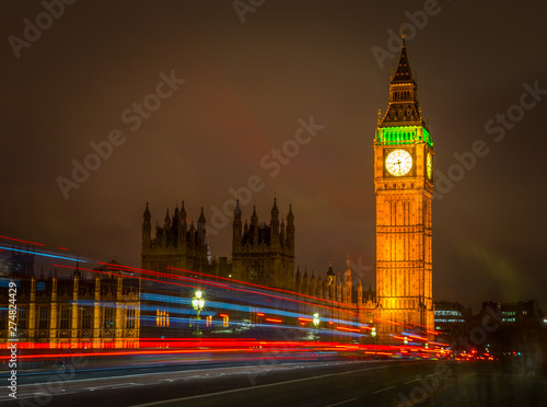 Big Ben Houses of Parliament Westminster Palace gothic architecture and Light trail from double decker bus passing on Westminster Bridge  London  England