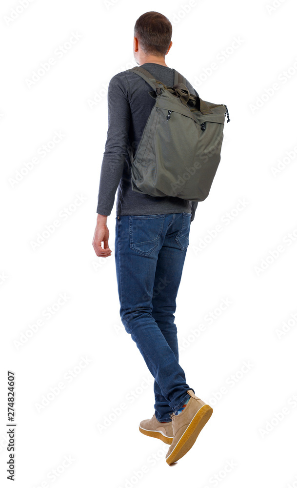 back view of walking man with green bag. back view of walking man with green bag.