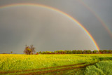double rainbow in summer after rain in the field. Nature after the rain. double Rainbow