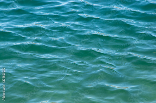 Rippled Ocean Surface. Blue-green coloured rippled ocean surface with shadows.