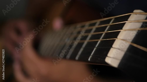 Close up vibrating string acoustic guitar