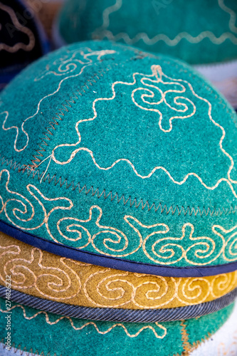 Kyrgyz headdress hats made of felt with a national ornament closeup. Market. Travel. Kyrgyzstan photo