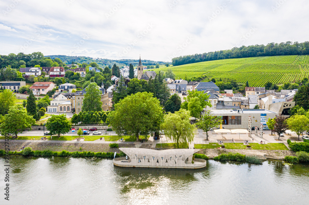 Fototapeta premium Aerial view of Schengen town center over River Moselle, Luxembourg, the place where Schengen Agreement signed, the birthplace of a Europe without borders. Tripoint of borders with Germany and France
