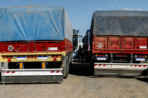 View from behind of two parked cargo trucks