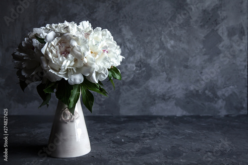 Beautiful peonies on grey concrete background. Wedding, birthday, gift or women's day concept