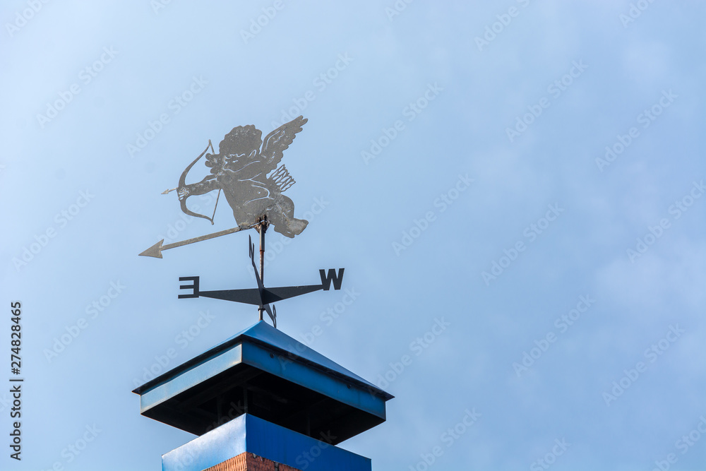 A weathervane of an angel on the roof A weathervane of an angel on the roof
