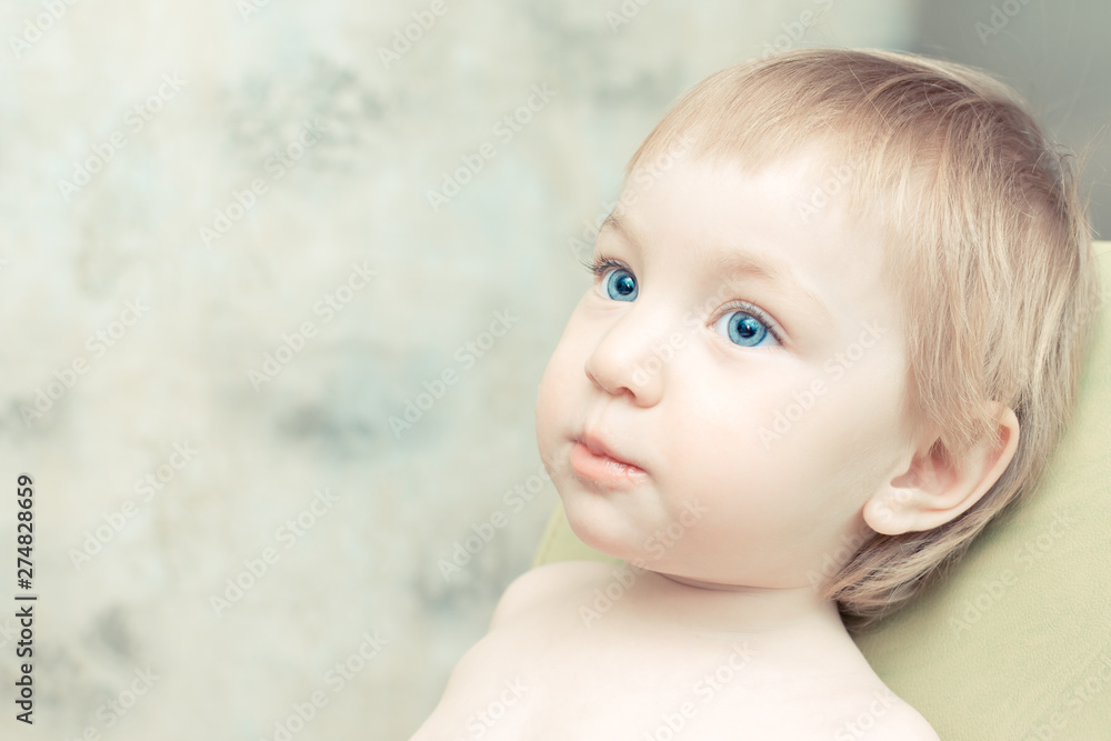 Beautiful child with big blue eyes sitting on kitchen chair. Beautiful child with big blue eyes sitting on kitchen chair.