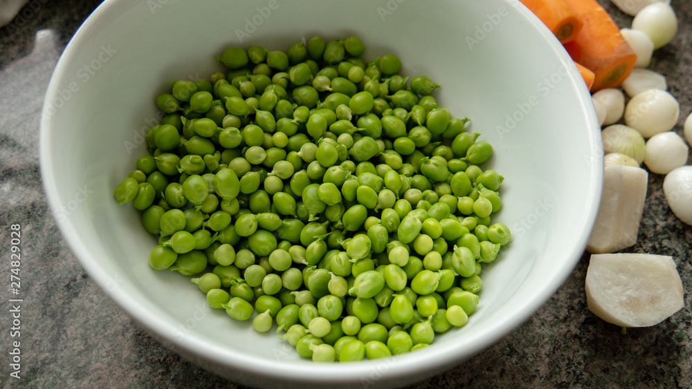 white bowl with the fresh organic green peas white bowl with the fresh organic green peas