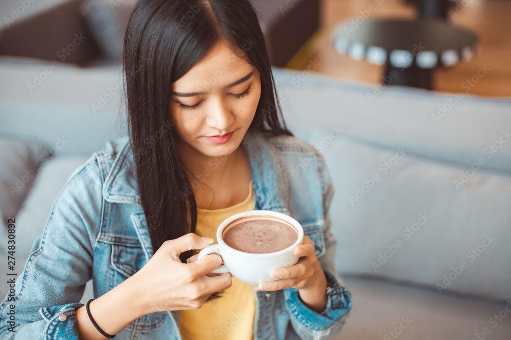 Attractive Asian woman drinking coffee.cheerful girl drinking coffee or tea in morning Attractive Asian woman drinking coffee.cheerful girl drinking coffee or tea in morning