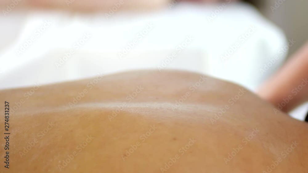 Close up of hands doing back massage Close up of hands doing back massage