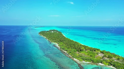 Aerial view of a tropical island with palm trees on it. In a strip of truquoise water in the sea of bali. photo