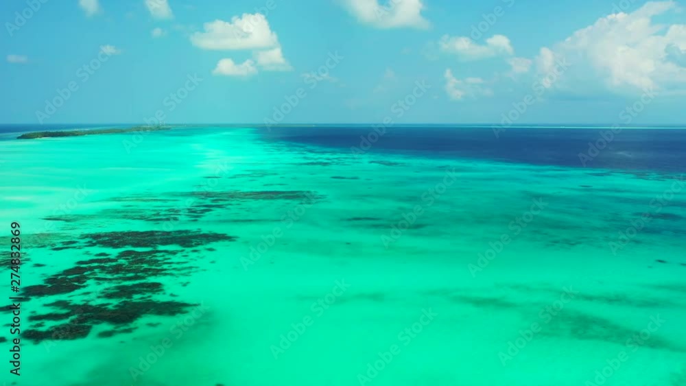 Aerial view of the turquoise greenish water of the Gulf of Thailand with some reefs in it. Slow Dolly out. Aerial view of the turquoise greenish water of the Gulf of Thailand with some reefs in it. Slow Dolly out.