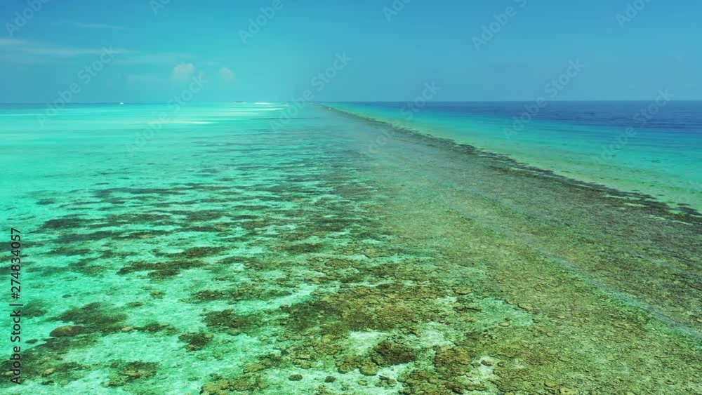 Aerial view of a a flight low above a reef in turquoise water. In Jamaica. Dolly out Aerial view of a a flight low above a reef in turquoise water. In Jamaica. Dolly out