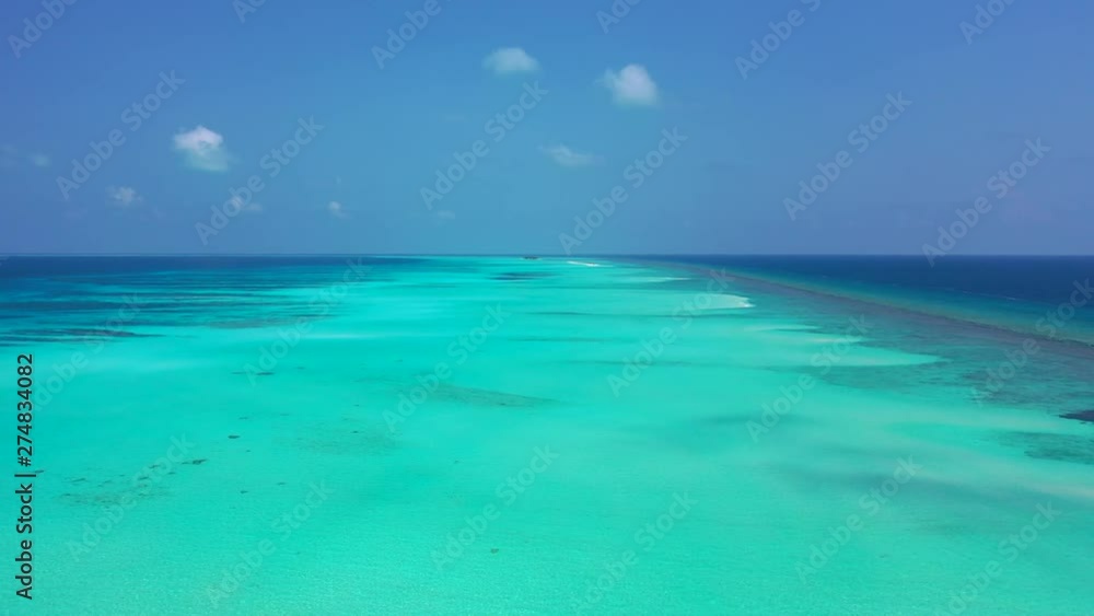 Aerial perspective of a flight above turquoise water that is surrounded by blue water on the left and right. Some reefs and sandbanks here in Jamaica. Dolly in Aerial perspective of a flight above turquoise water that is surrounded by blue water on the left and right. Some reefs and sandbanks here in Jamaica. Dolly in