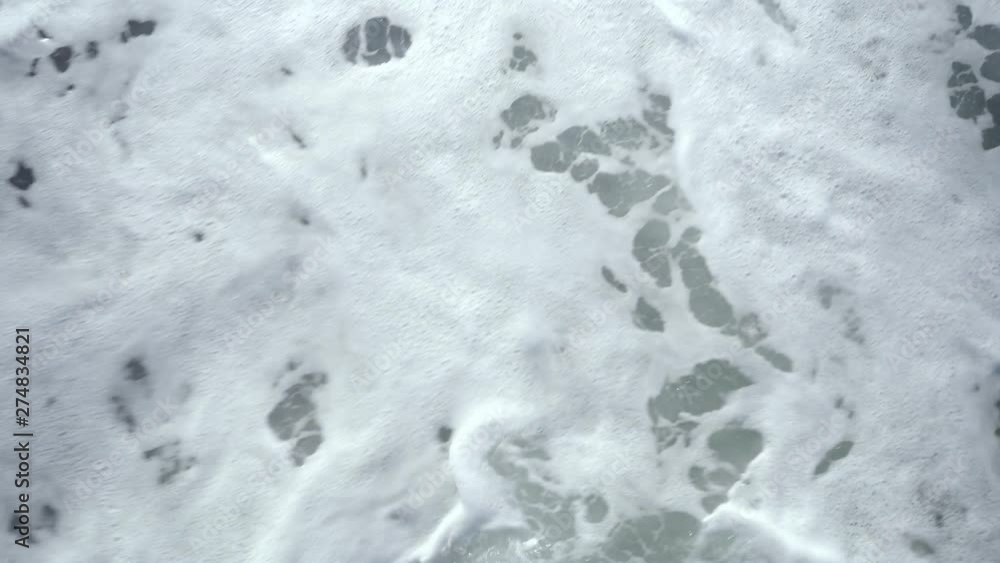 Top view of ocean wave and white sea foam. Top view of ocean wave and white sea foam.