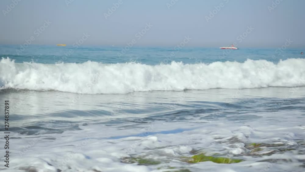Beautiful view of splashing blue waves near the beach. Beautiful view of splashing blue waves near the beach.