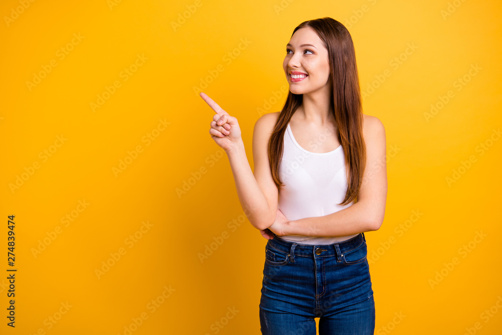 Close up photo beautiful she her lady perfect appearance hand arm index finger indicate empty space news advising buy buyer wear casual jeans denim white tank-top isolated bright yellow background Close up photo beautiful she her lady perfect appearance hand arm index finger indicate empty space news advising buy buyer wear casual jeans denim white tank-top isolated bright yellow background