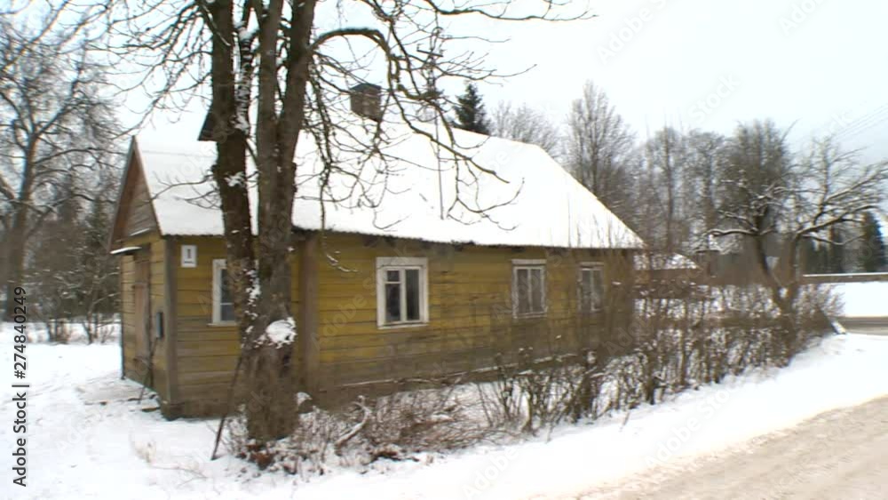 Wooden village houses and road in winter Wooden village houses and road in winter