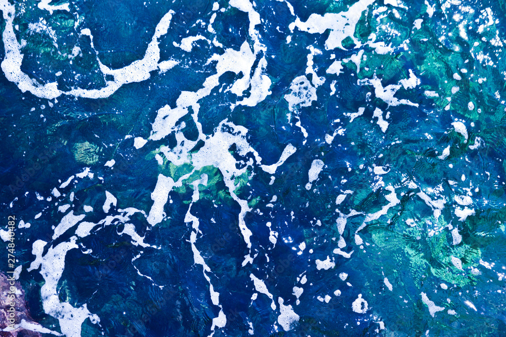 Blue sea waves background with sea foam