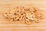 Hard sweet mini pretzels on a wooden surface