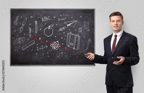 Handsome young teacher with laser pointer teaching 