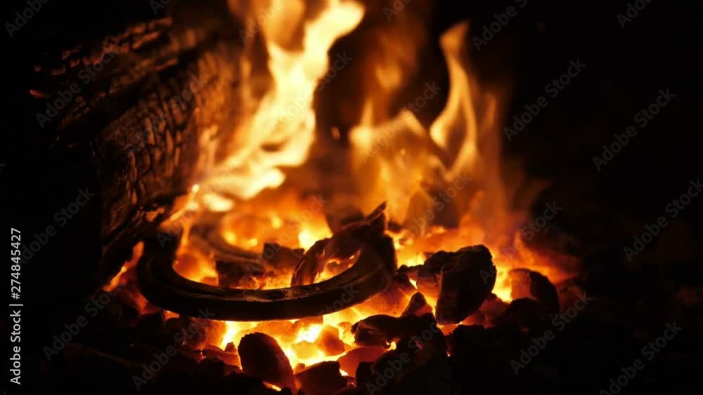 Ominous furnace flame with raging forks in an old Ukrainian smithy workshop Ominous furnace flame with raging forks in an old Ukrainian smithy workshop