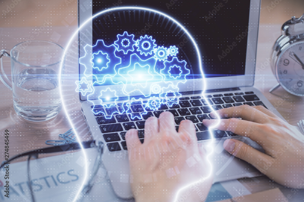Man typing on keyboard background with brain hologram. Concept of big Data. Man typing on keyboard background with brain hologram. Concept of big Data.