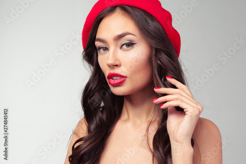 Portrait of a cheerful woman wearing red beret