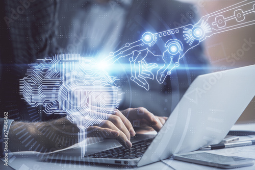 Man typing on keyboard background with brain hologram. Concept of big Data.