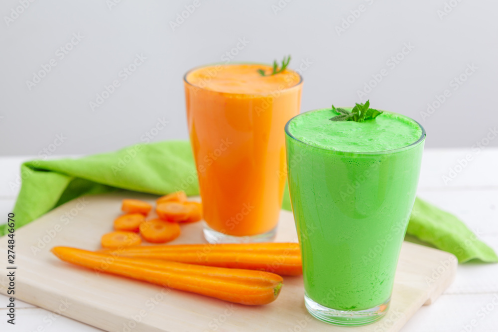 Fototapeta premium Green smoothie in glass over rustic wooden background