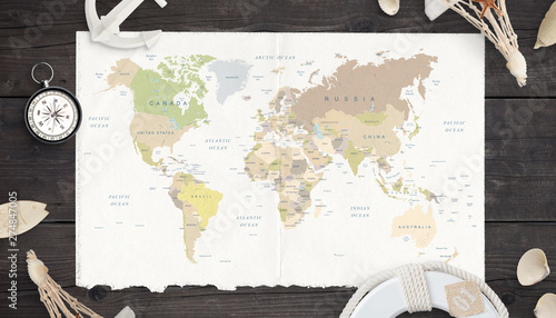 Map of the world on old paper surrounded by compass, anchor, lifebelt and shells.