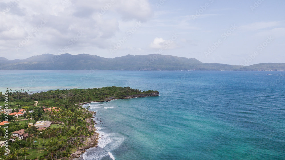 White sandy beach on a tropical island and clear sea. Top View of paradise tropical beach in sunny day. Beautiful sea view, shot by drones. Coral reef Aerial view. Uninhabited island White sandy beach on a tropical island and clear sea. Top View of paradise tropical beach in sunny day. Beautiful sea view, shot by drones. Coral reef Aerial view. Uninhabited island