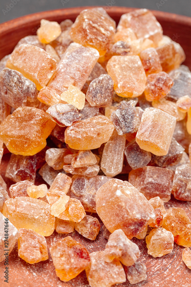 brown sugar rock organic crystalline close up on dark background brown sugar rock organic crystalline close up on dark background
