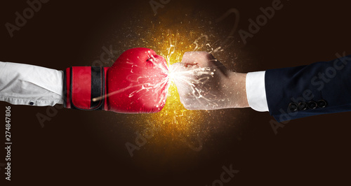 Two hands fighting with orange dust, spark, glow and smoke concept  © ra2 studio