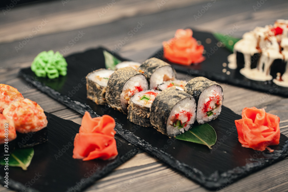 Healthy food. Japanese restaurant. Sushi roll on a black background Healthy food. Japanese restaurant. Sushi roll on a black background