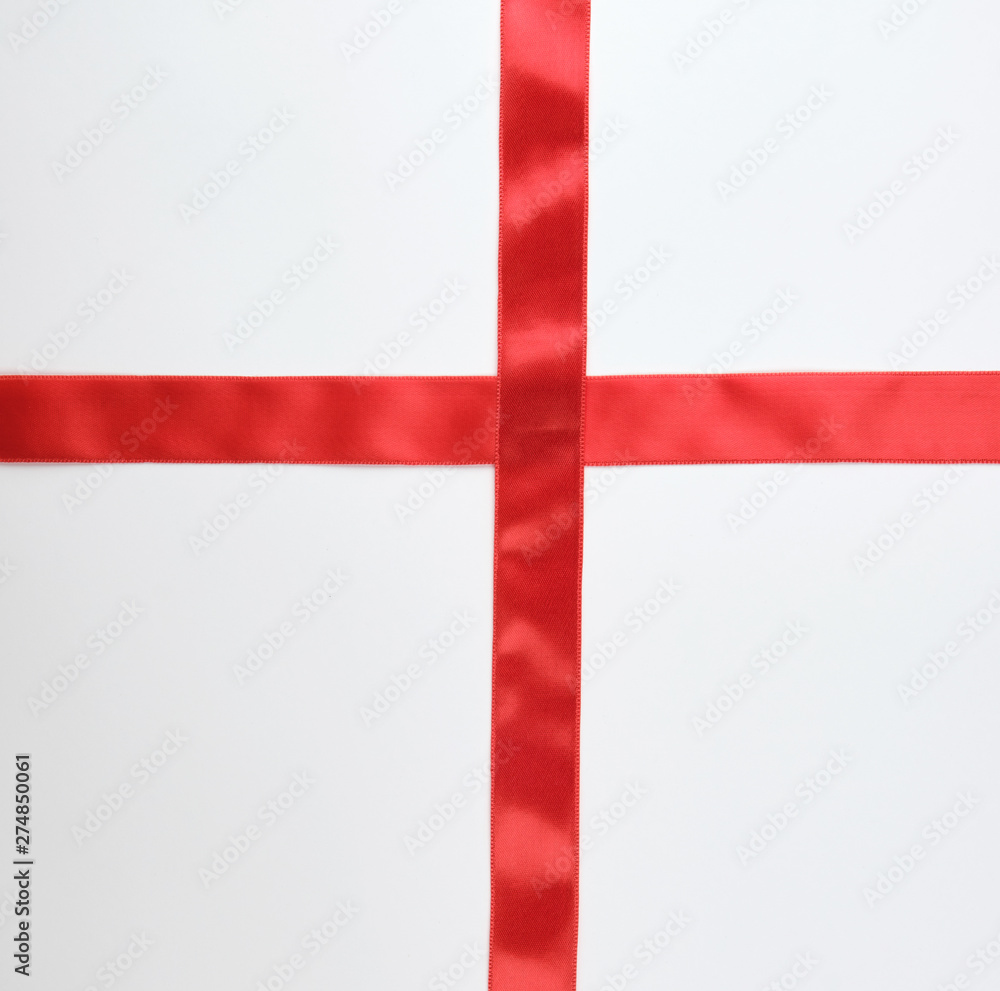 Fototapeta premium red satin ribbon cross to cross on white background