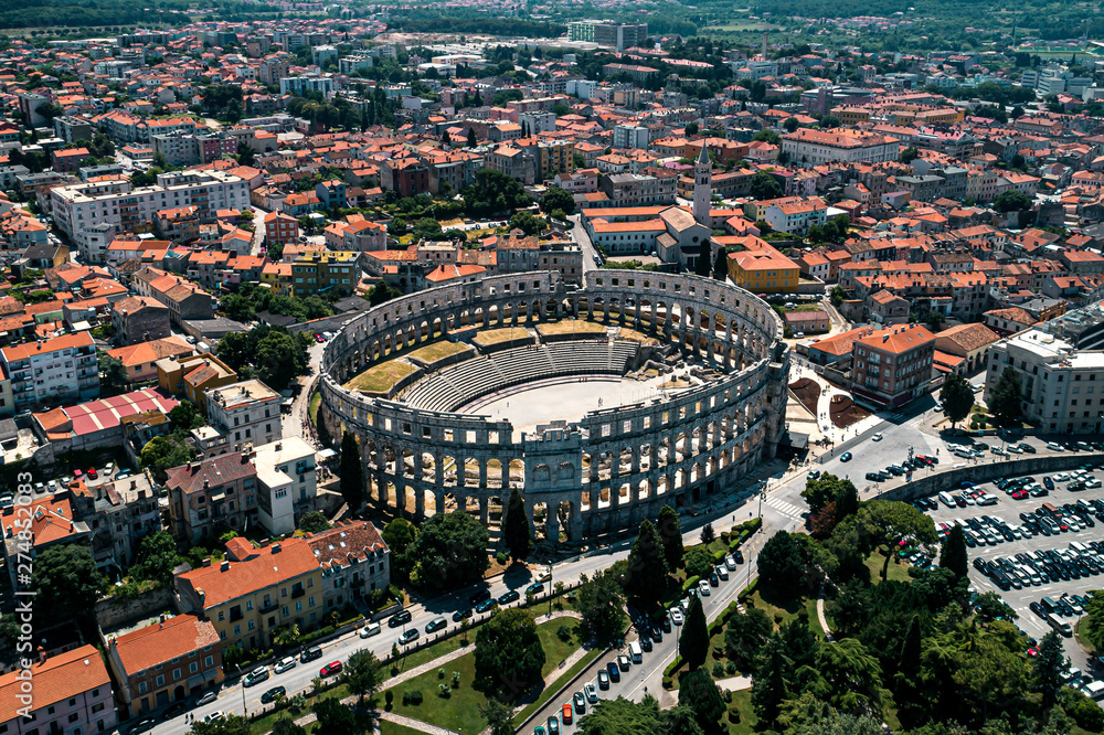 Pula Arena in Croatia and Pula city old town travel destination aerial view
